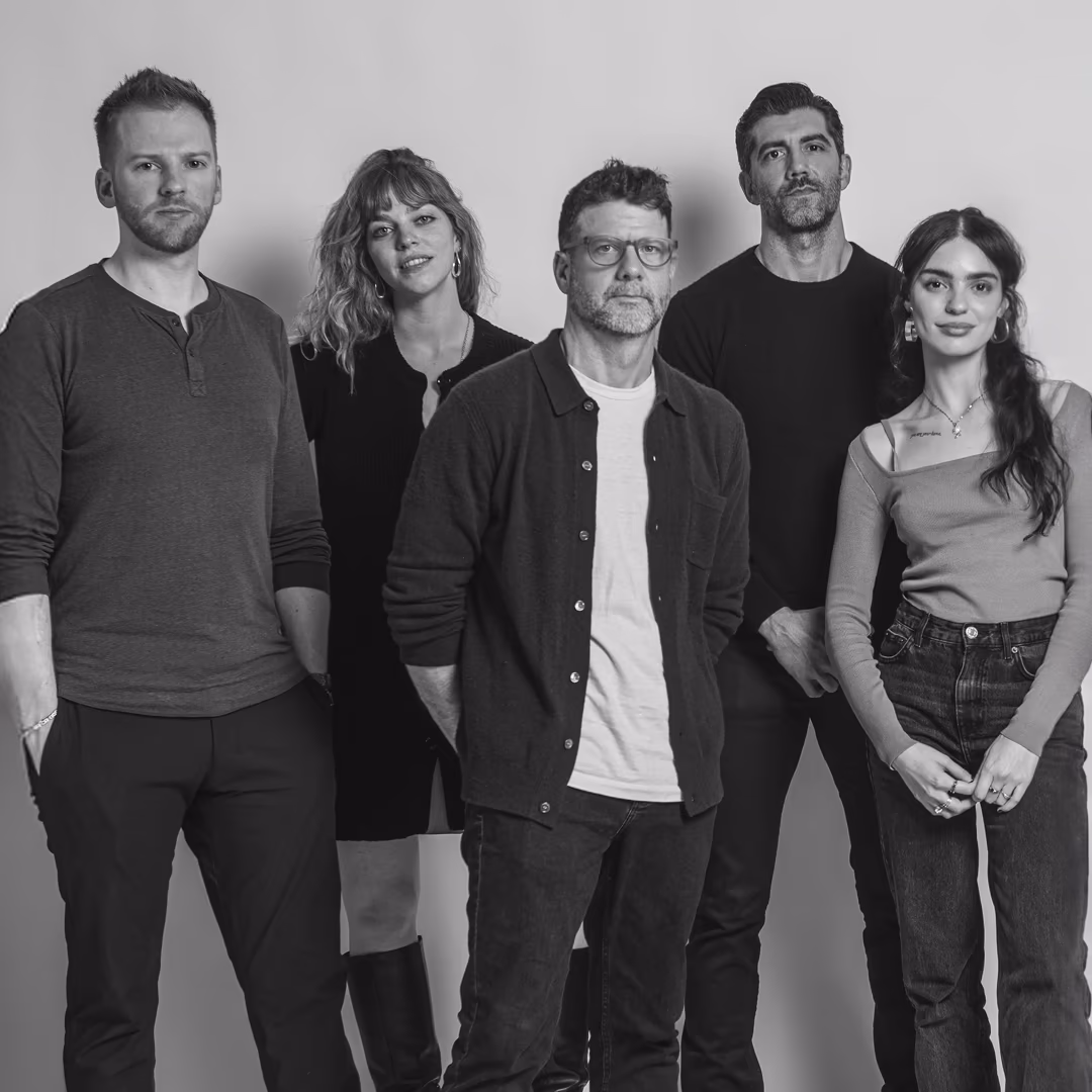 Piranha team — five members in editorial black-and-white studio portrait